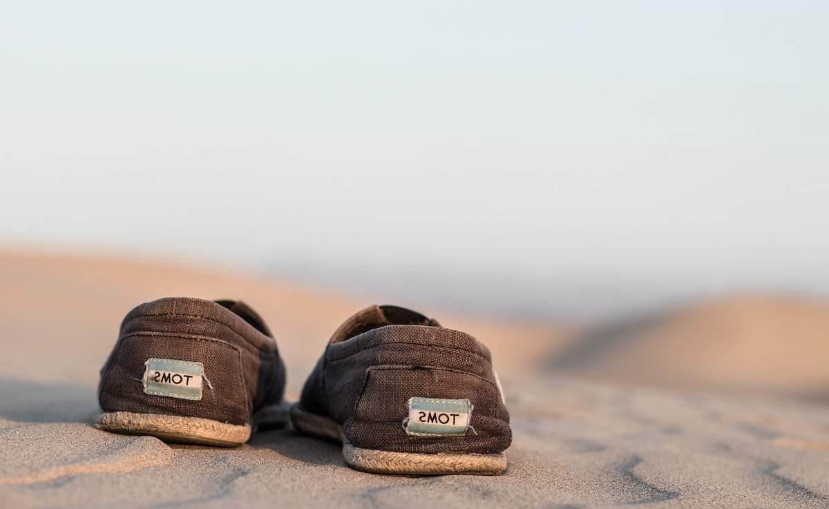 united states pair off black Toms shoe during daytime photography footwear